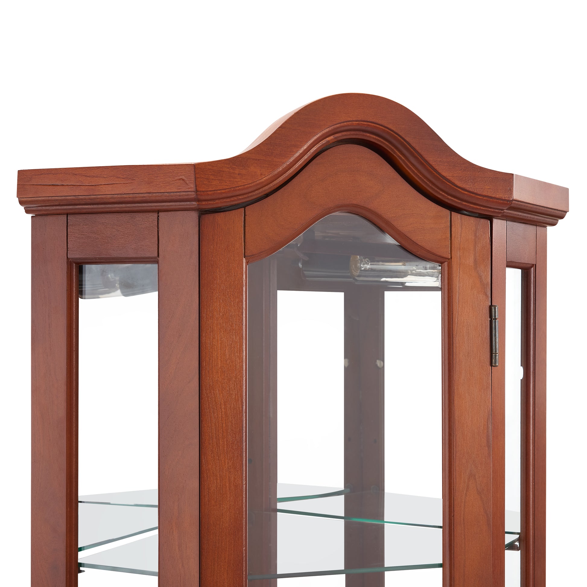 Closeup of a cherry wood curio cabinet with glass shelves and decorative molding