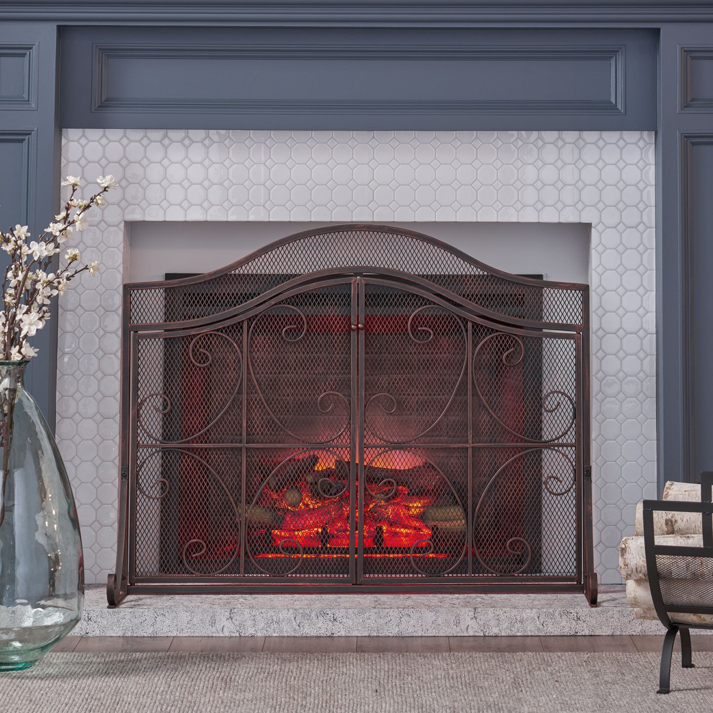 Antique bronze fireplace screen with scrollwork and arch top