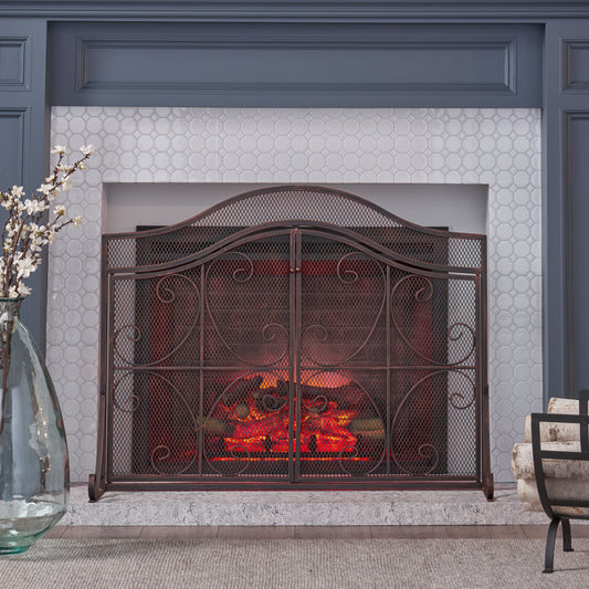 Antique bronze fireplace screen with scrollwork and arch top