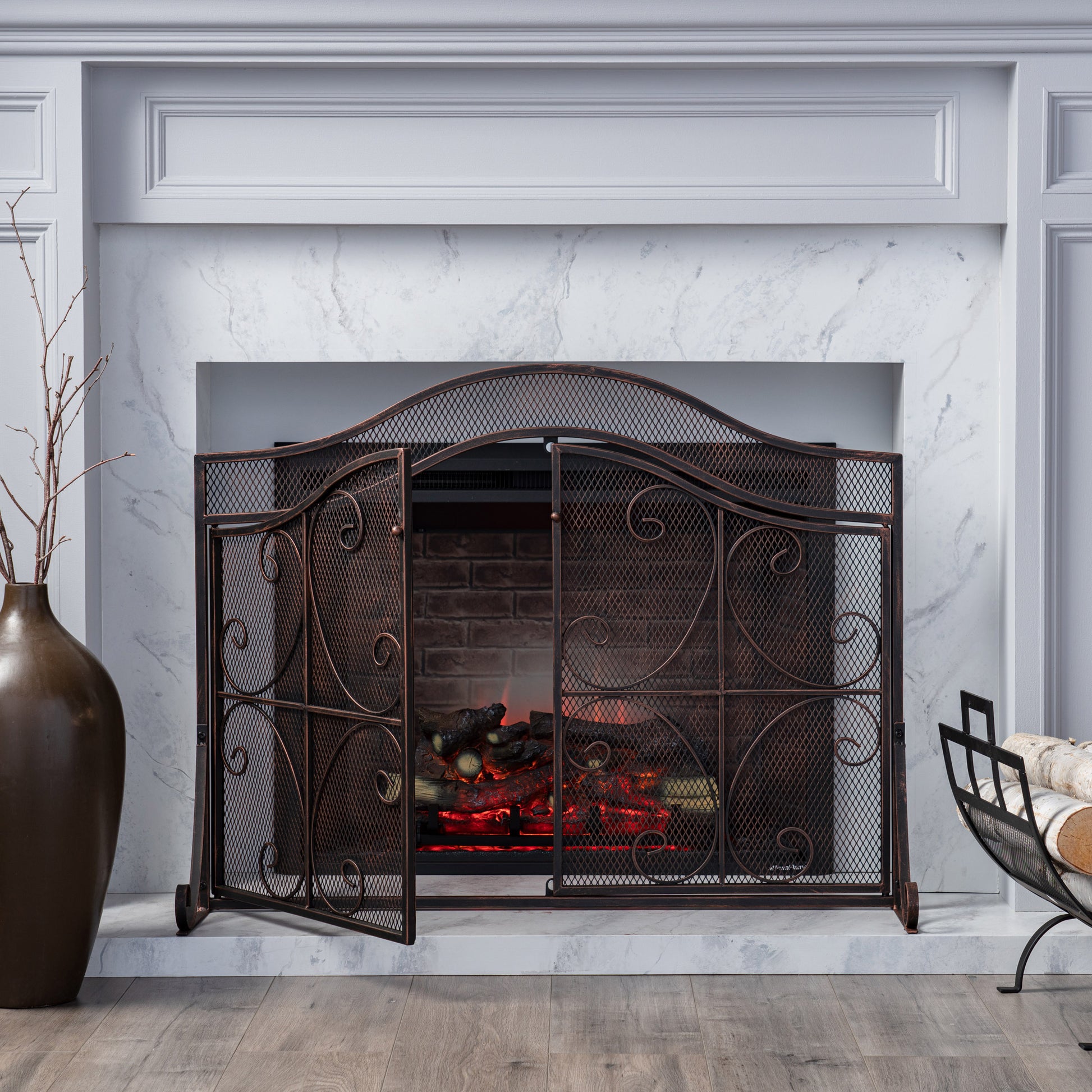 Ornate bronze fireplace screen with mesh panel and scrollwork for safety