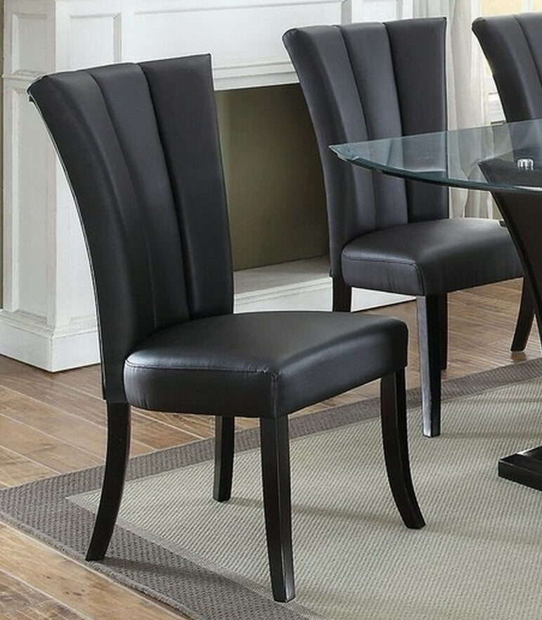 Black faux leather dining chair with fluted back and dark wood legs