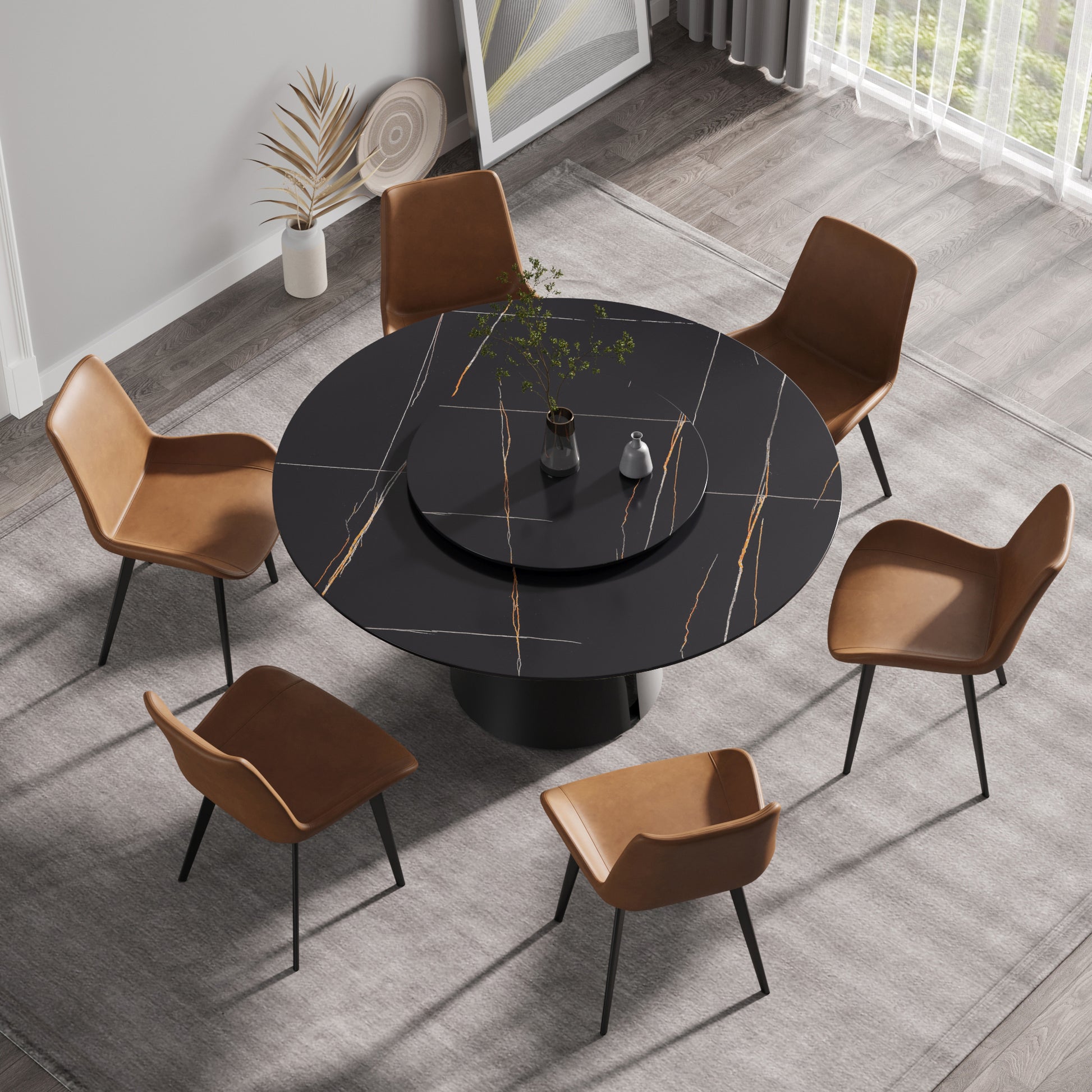Round black marble dining table with brass inlay and six brown leather chairs