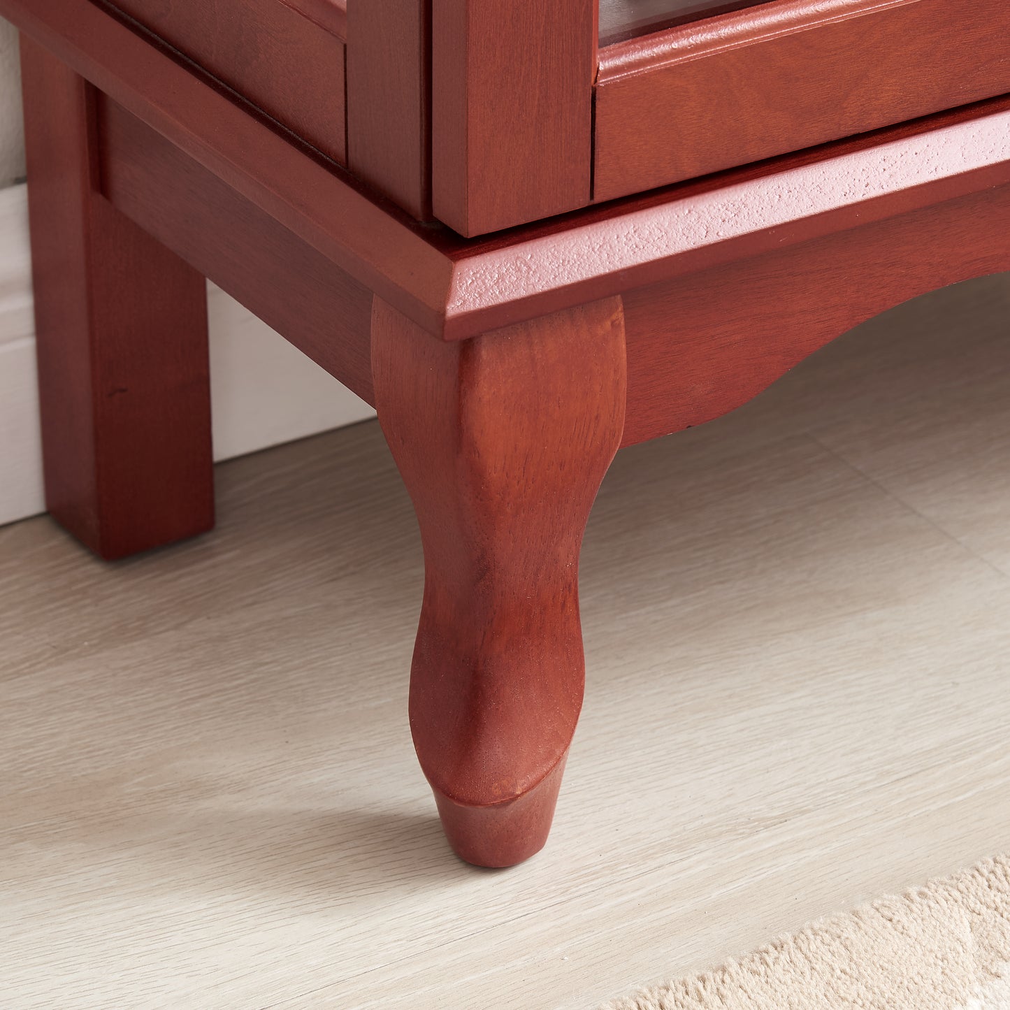 Dark cherry wood cabinet leg with carved detail
