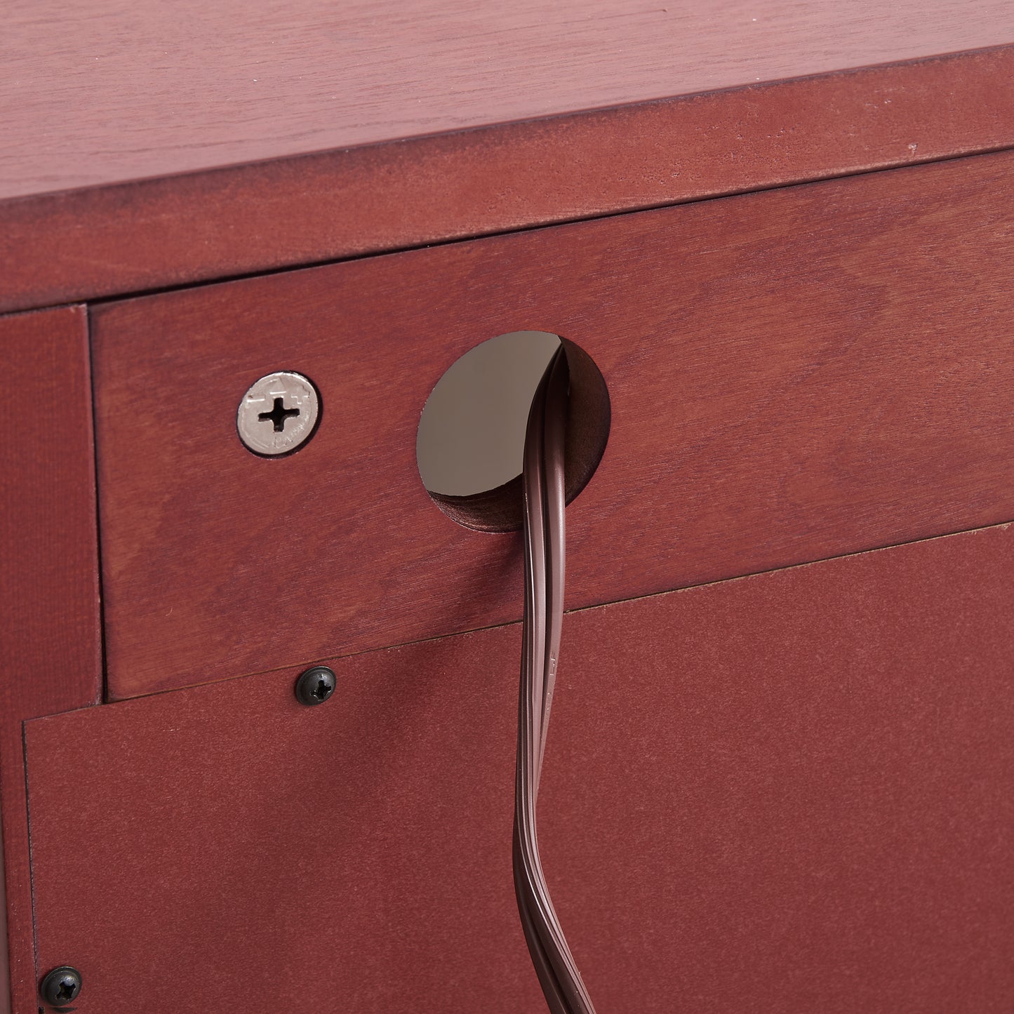 Cherry wood furniture detail with cable management hole
