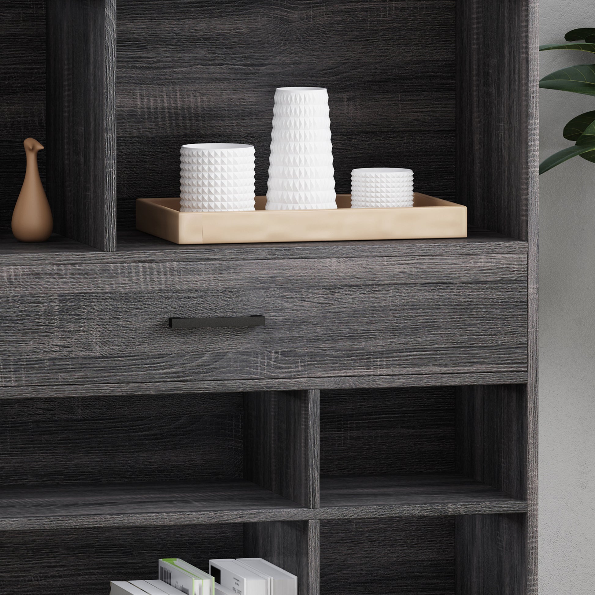 Dark wood bookcase with modern geometric vases and a sleek drawer