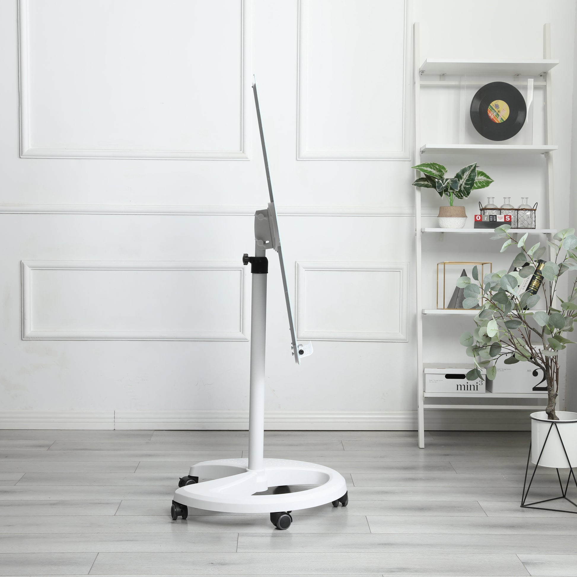White adjustable easel on a wheeled base for art studios