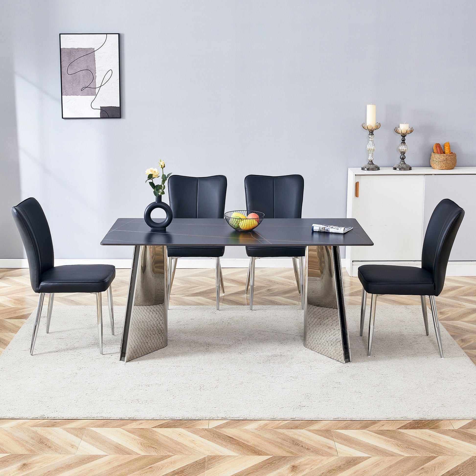 Modern black dining table with chrome legs and four faux leather chairs