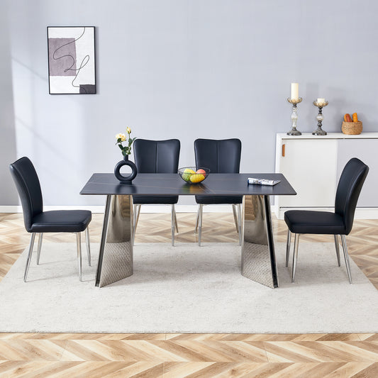 Modern black dining table with chrome legs and four faux leather chairs