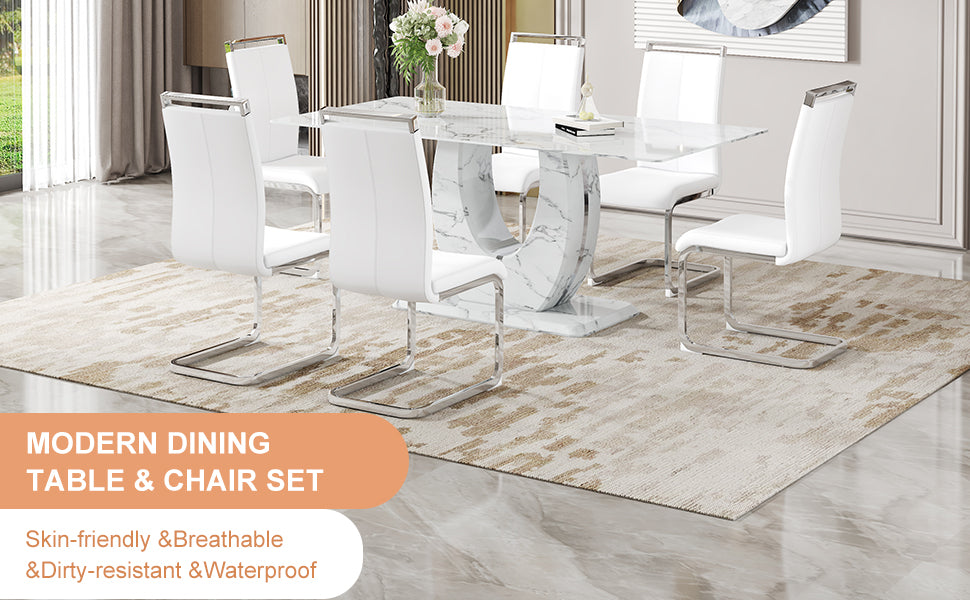 White leather dining chairs with chrome legs around a marbleeffect dining table