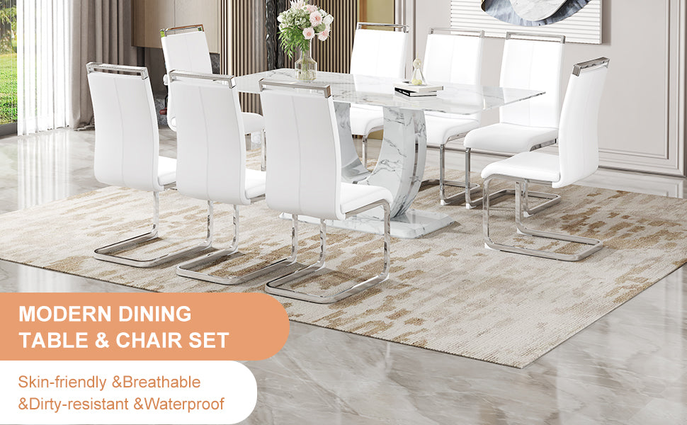 White faux leather dining chairs with chrome legs arranged around a modern marble dining table set