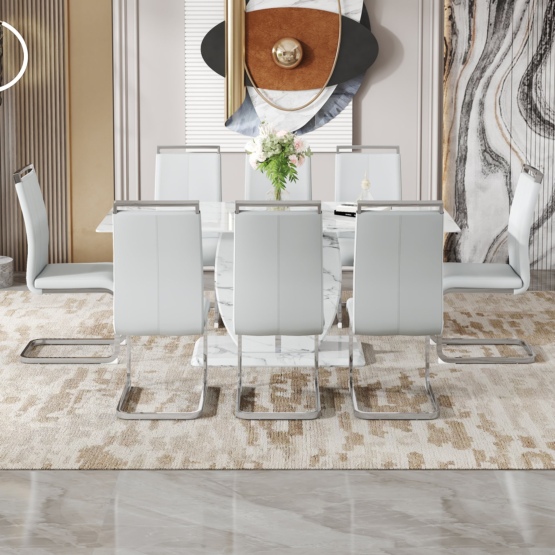 White faux leather dining chairs with chrome sled legs around a marble dining table