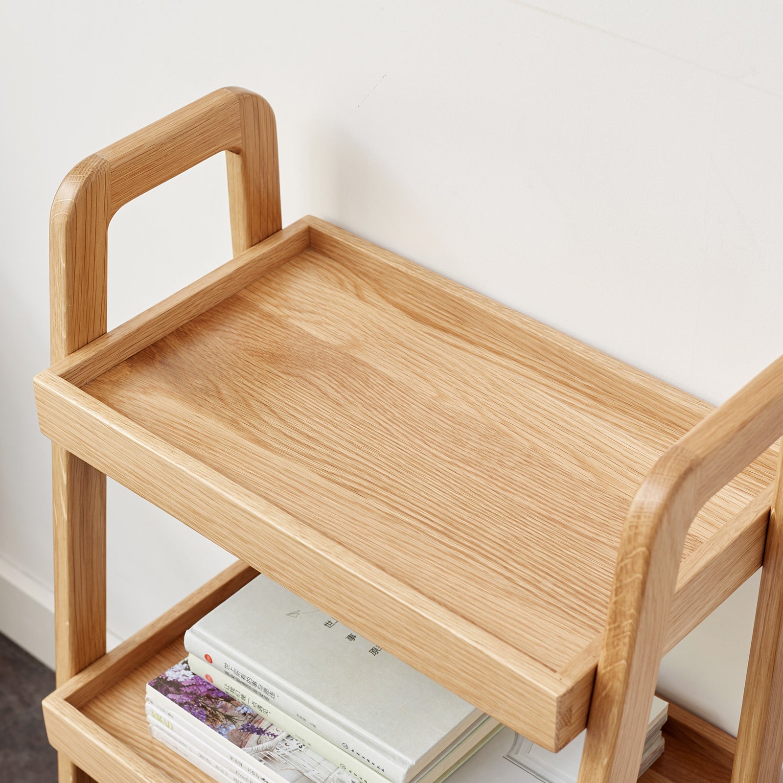 Natural oak wood twotier shelving unit with smooth rounded edges and integrated handles