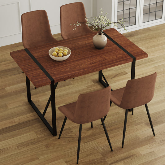 Modern walnut dining table with sleek black legs and four brown upholstered chairs