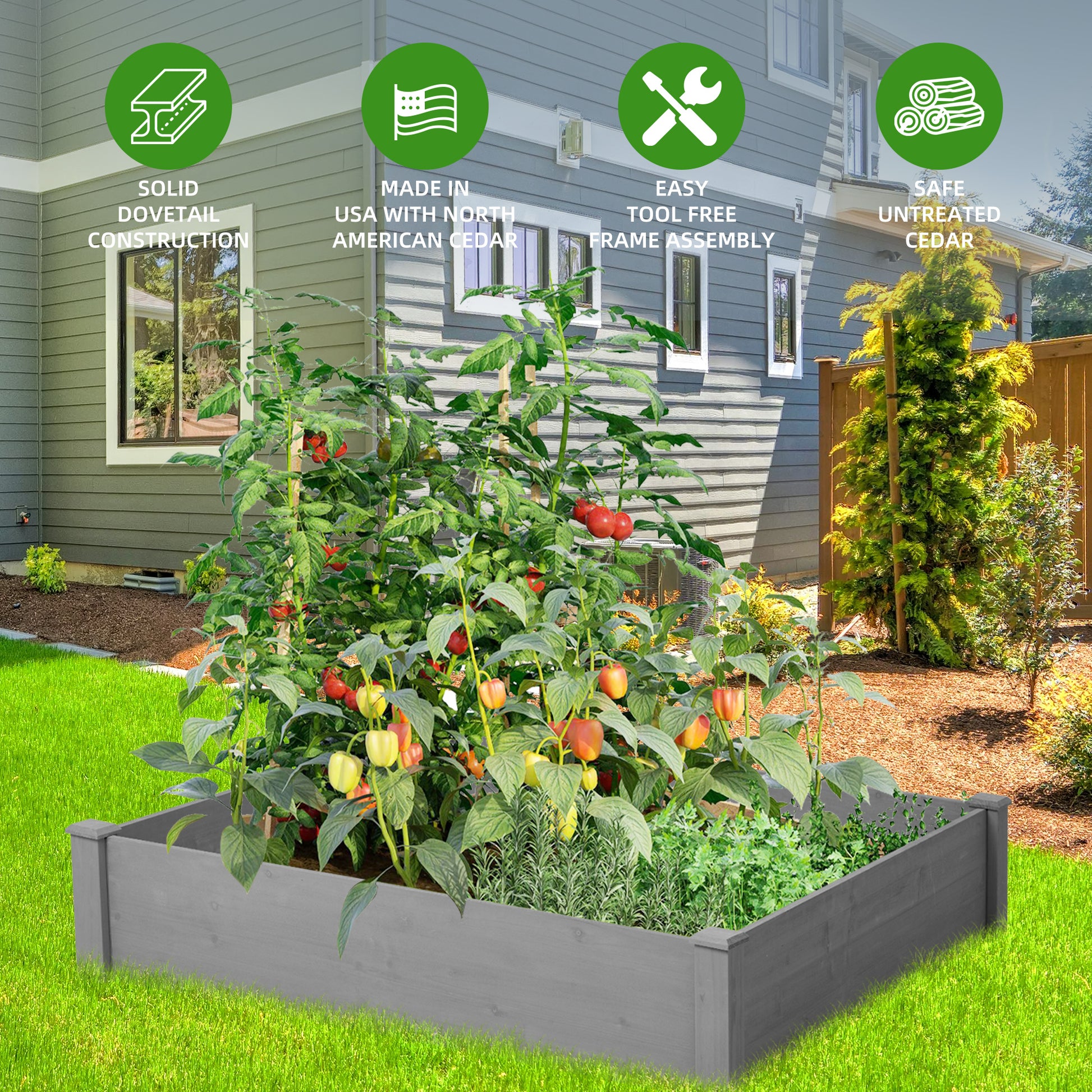 Grey wooden raised garden bed with lush tomato plants and peppers