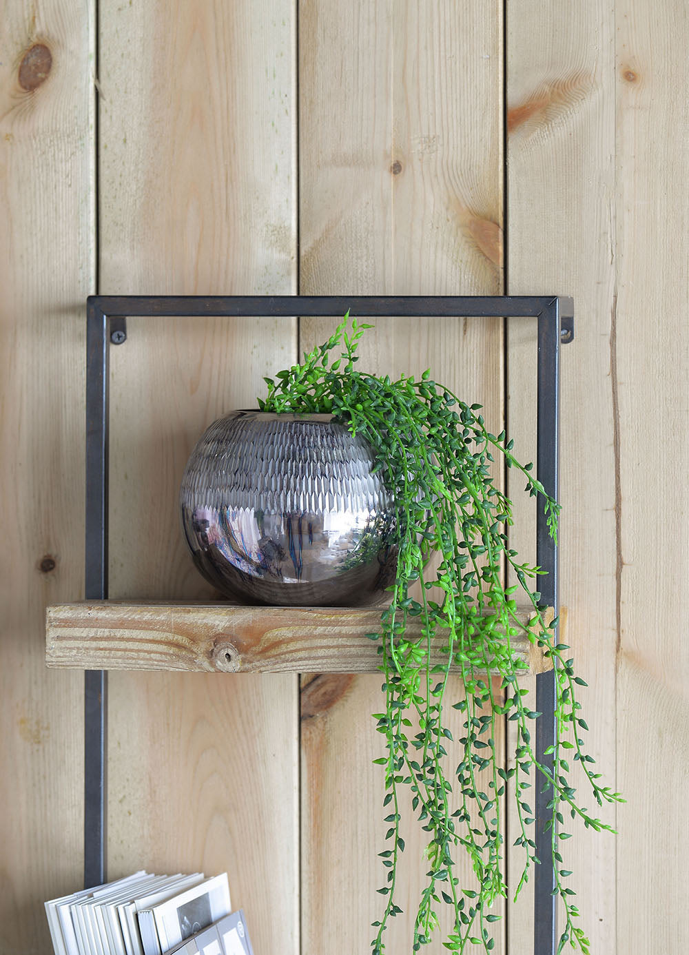 Silver textured round planter with cascading succulent plant
