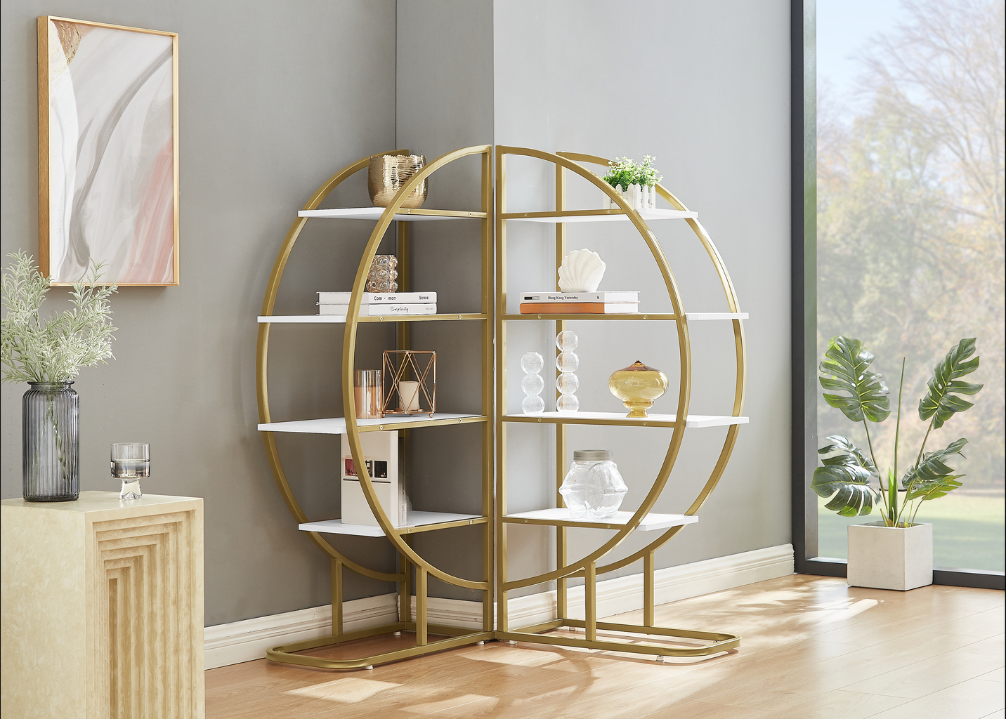 Modern gold circular bookshelf with white shelves displaying decor