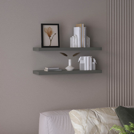Modern grey floating shelves with decorative objects including books and a vase