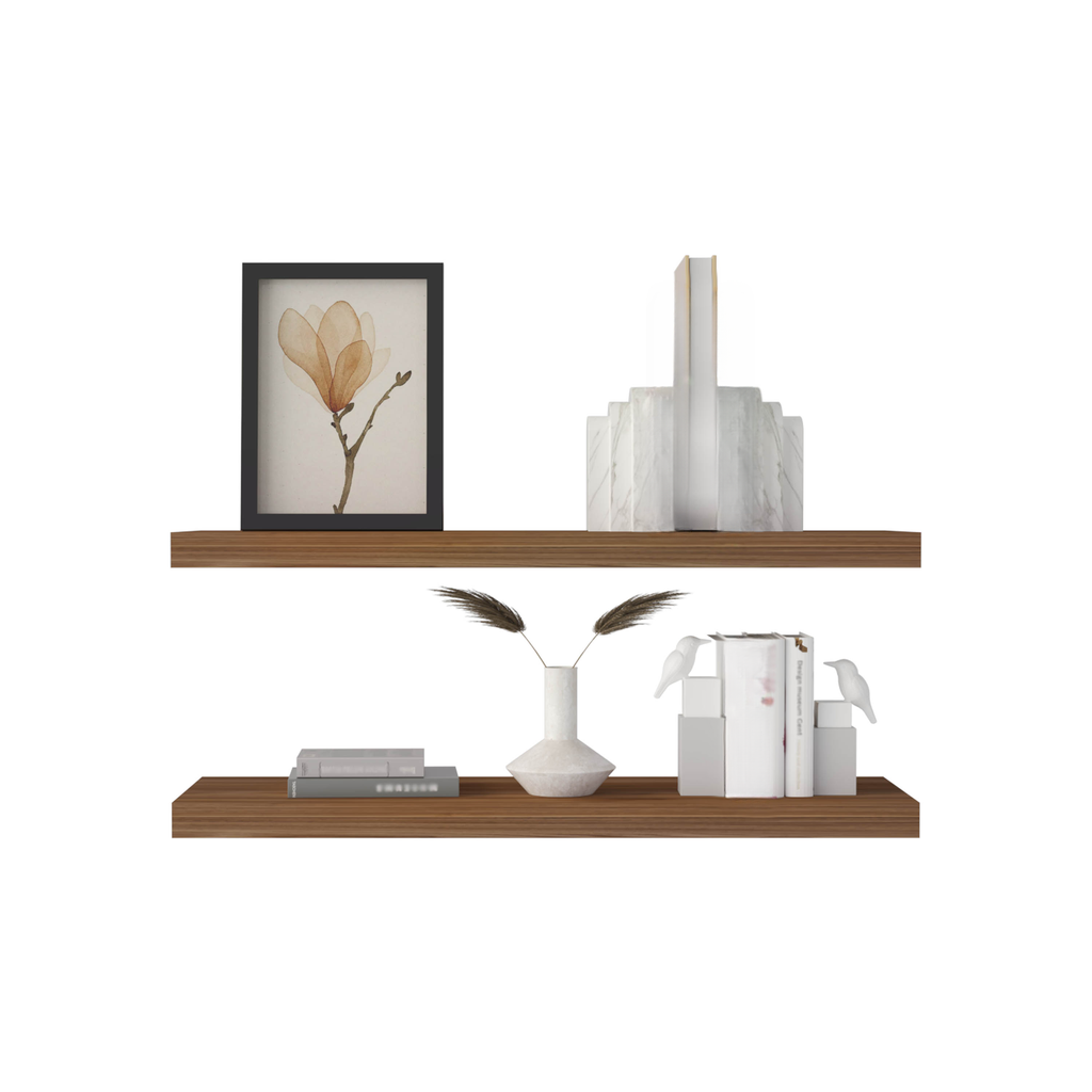 Framed watercolor magnolia art print on a wooden shelf