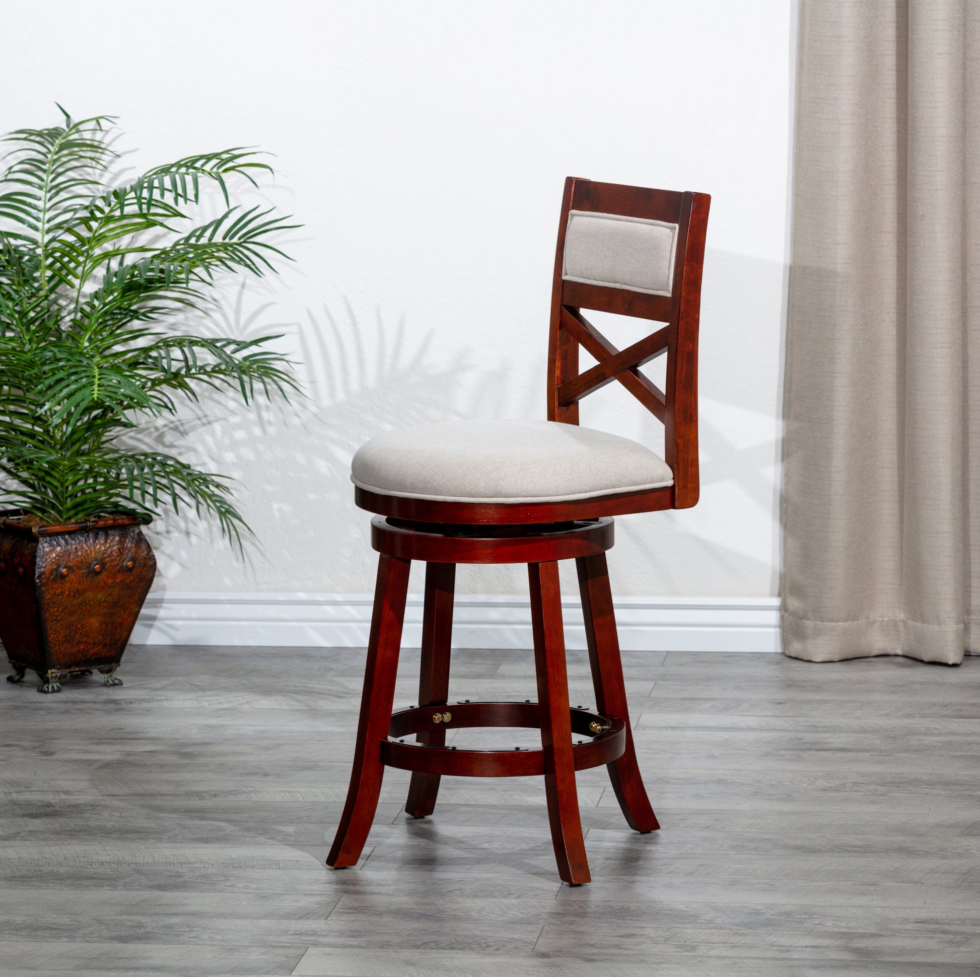 Cherry wood swivel bar stool with a beige upholstered seat and backrest
