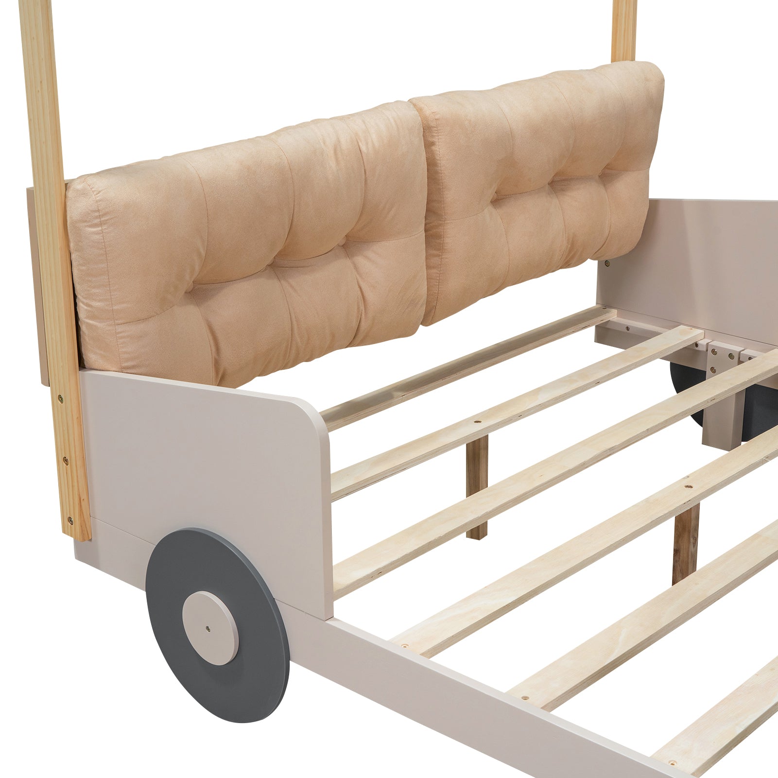 Tan tufted headboard on a light grey toddler bed frame with wooden accents and wheels