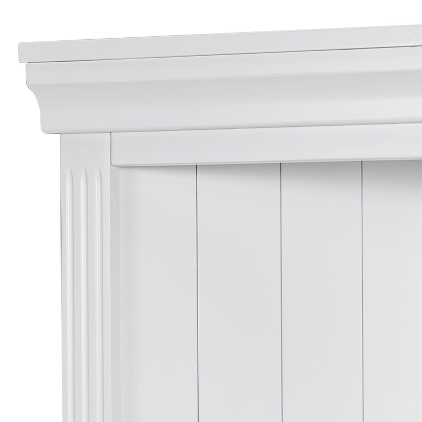 Closeup of a white wooden cabinet door with fluted detail