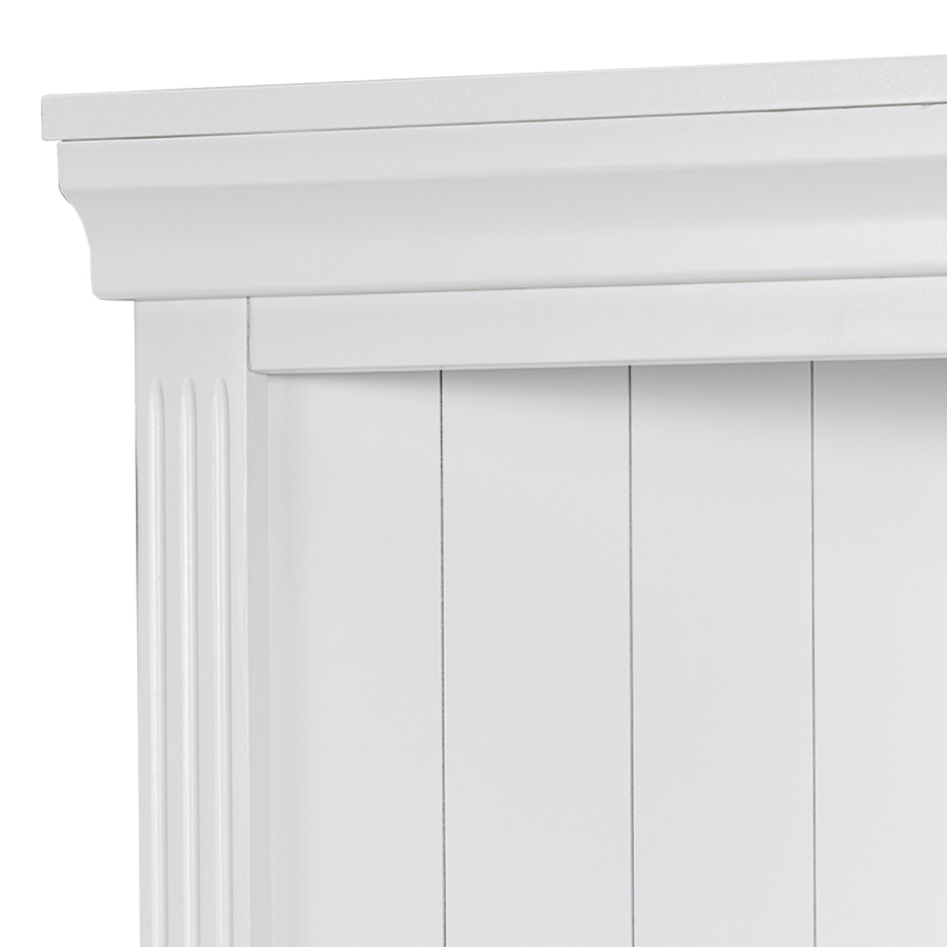 Closeup of a white wooden cabinet door with fluted detail