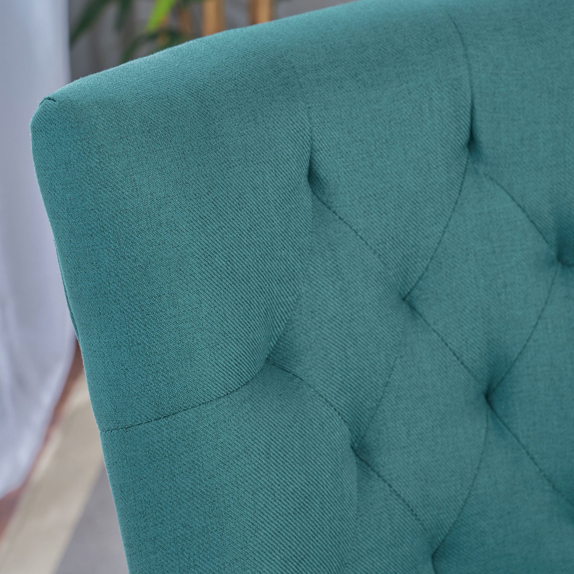Teal tufted upholstered chair detail