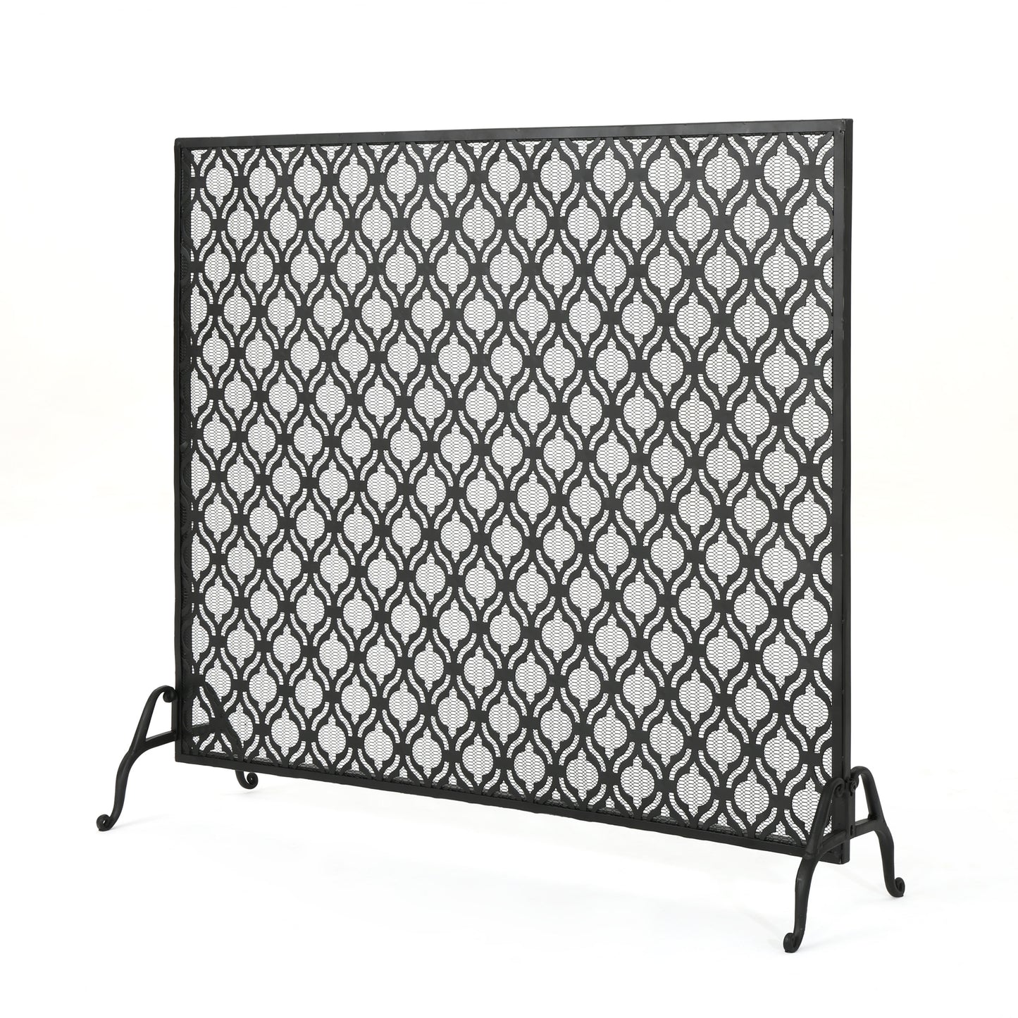 Black metal fireplace screen with intricate geometric cutouts