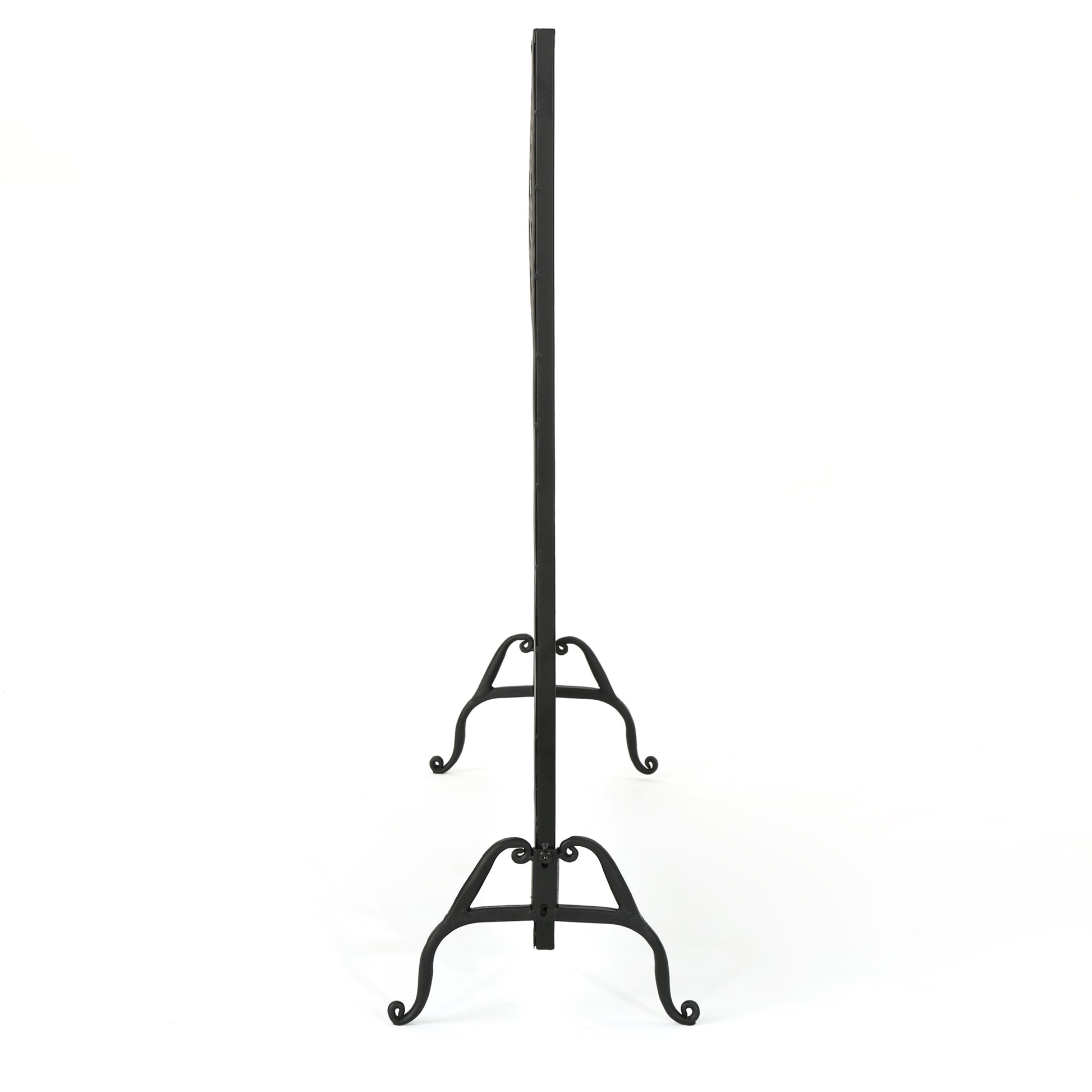 Black wrought iron fireplace screen with scrollwork legs