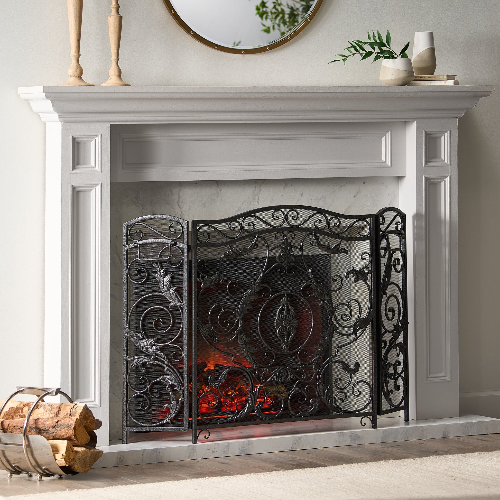 Ornate black metal trifold fireplace screen with scrolling floral design