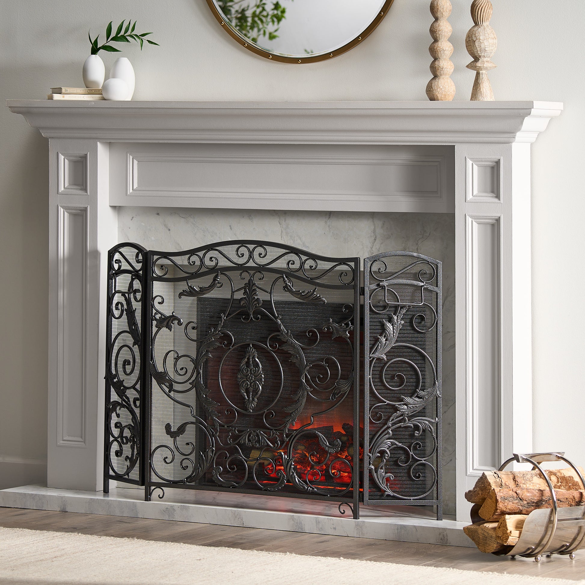 Black wrought iron fireplace screen with ornate scrollwork and leaf motifs