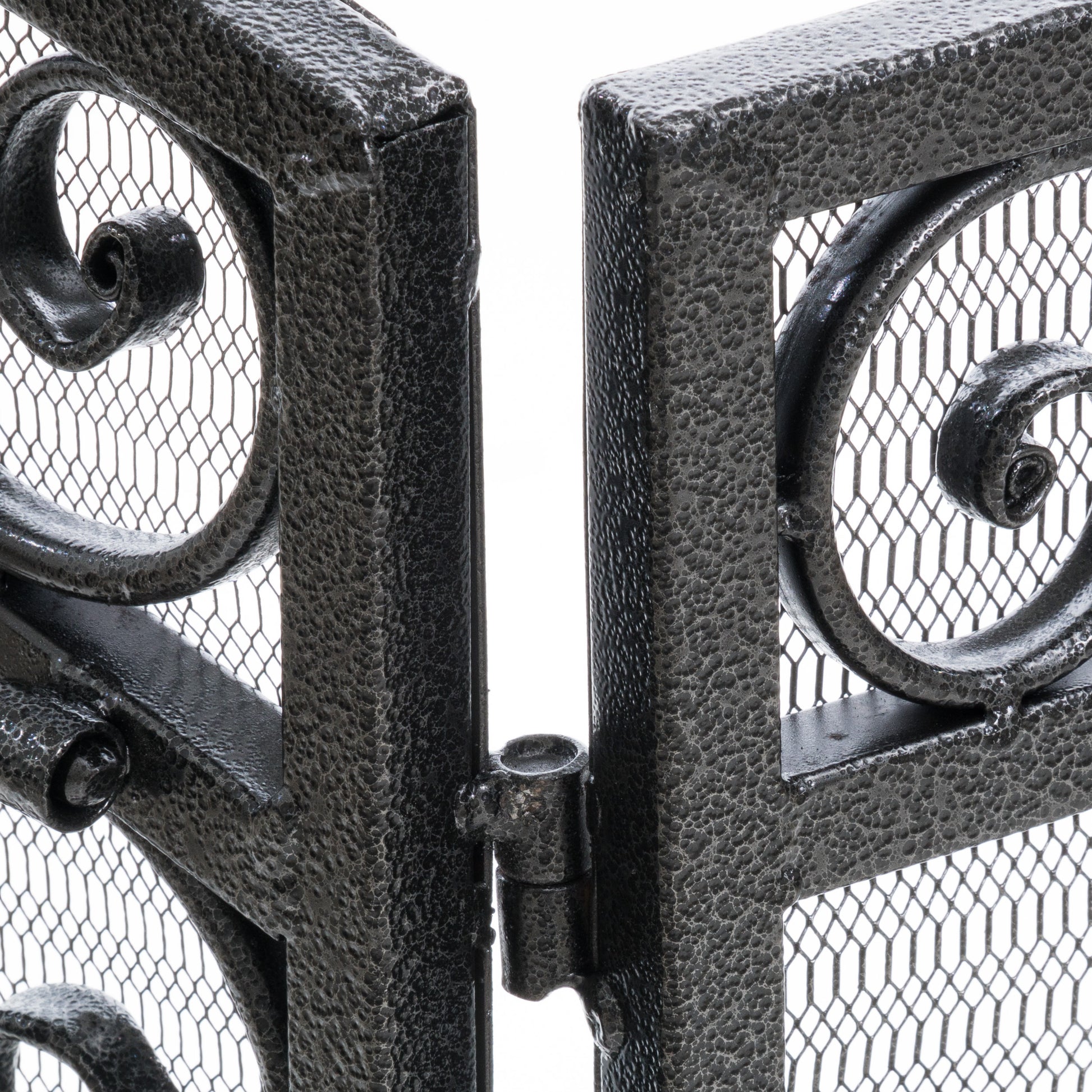 Close up of ornate wrought iron gate detail with mesh infill