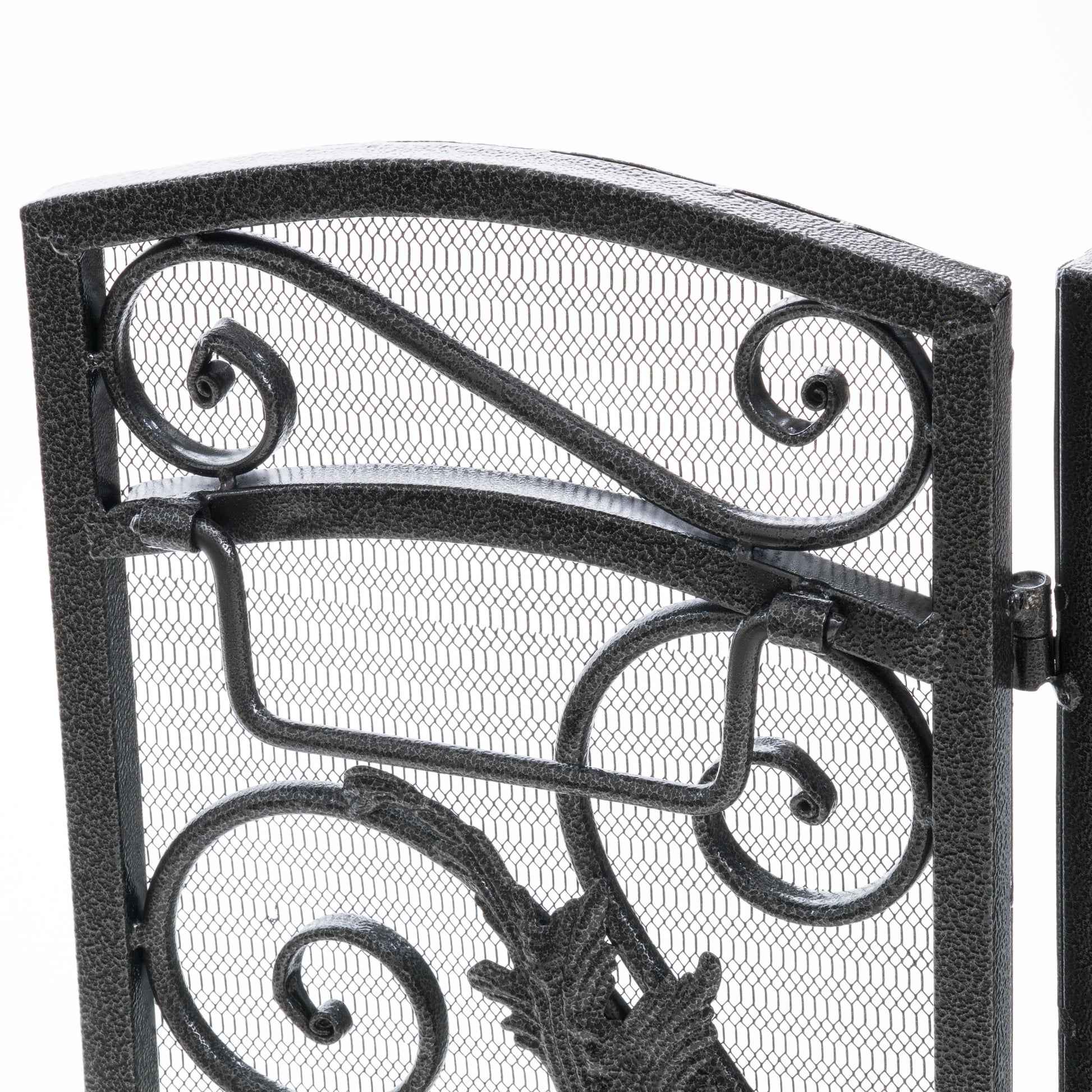 Black metal ornate fireplace screen with scrolling details and fine mesh