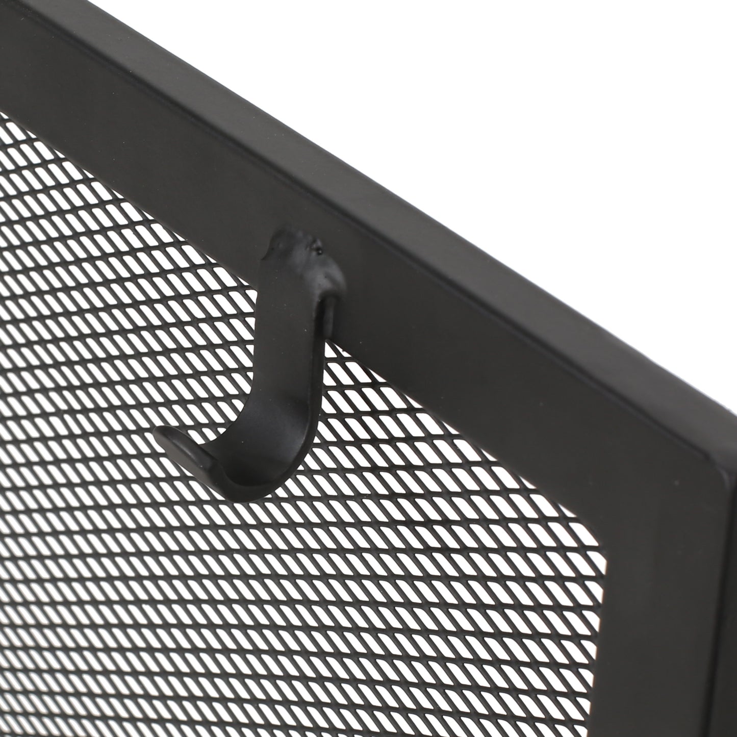 Black metal fireplace screen mesh with a curved hook detail for tools