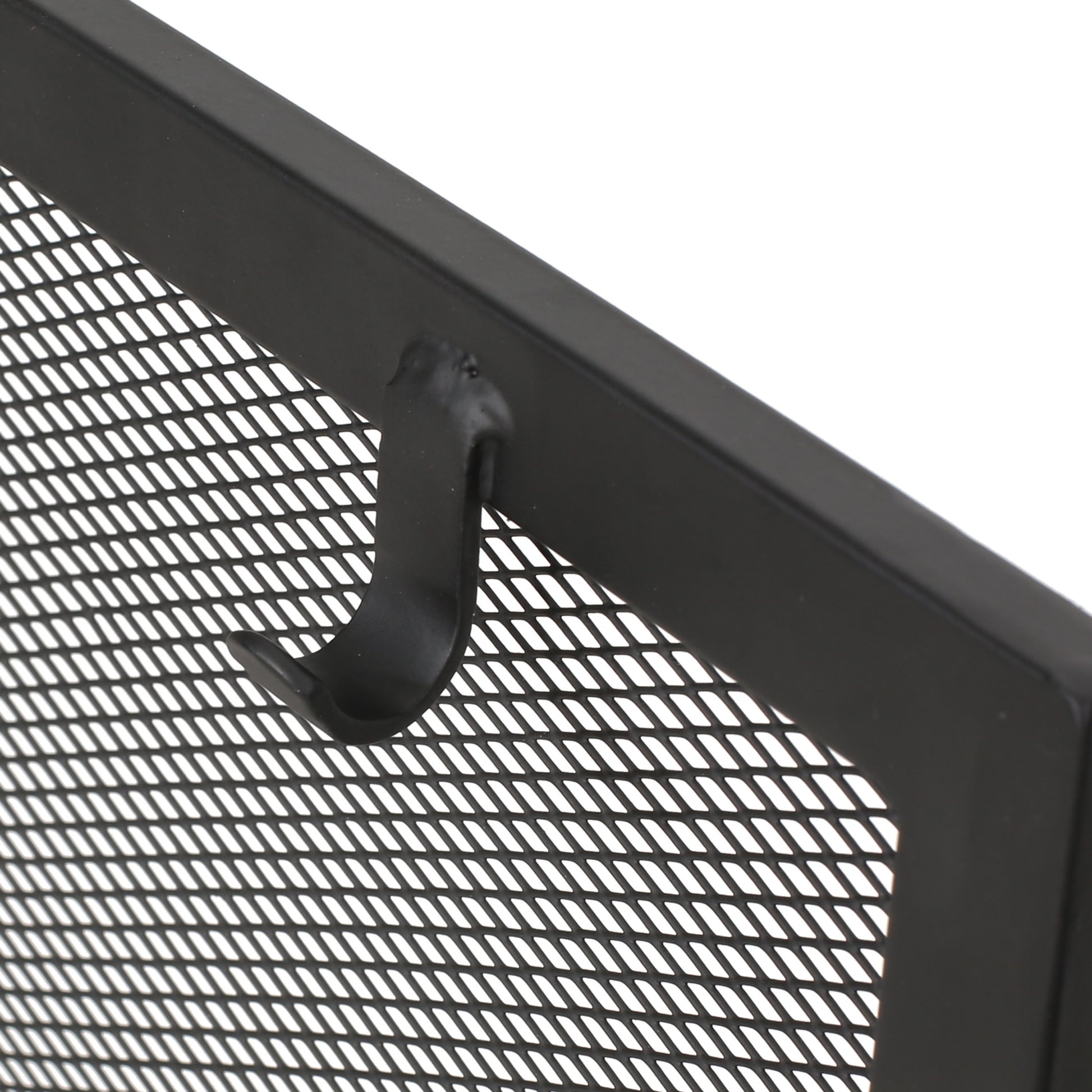 Black metal fireplace screen mesh with a curved hook detail for tools