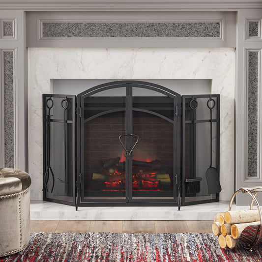 Black trifold wrought iron fireplace screen with arched top and hearth tools