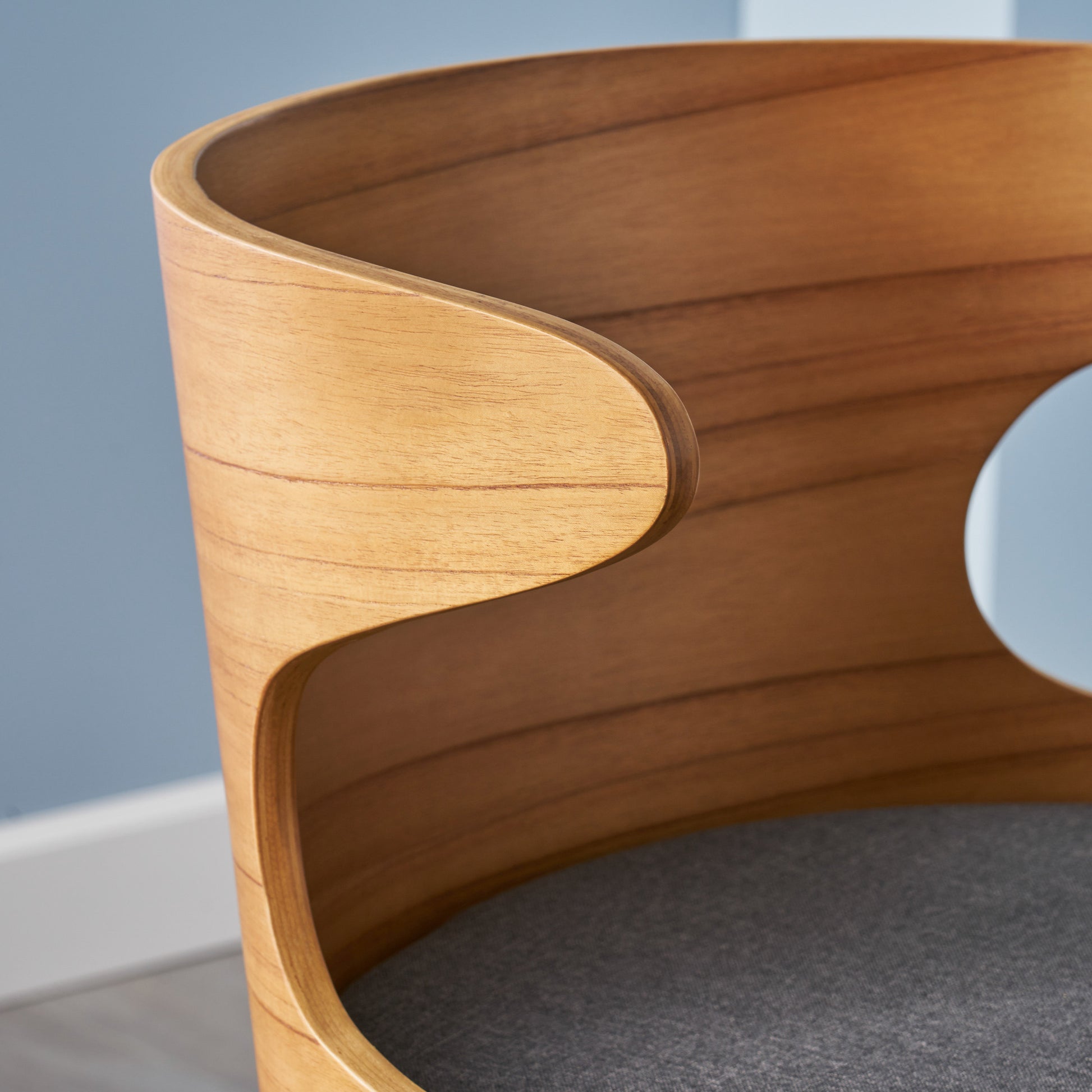 Curved natural wood accent chair with grey upholstered seat