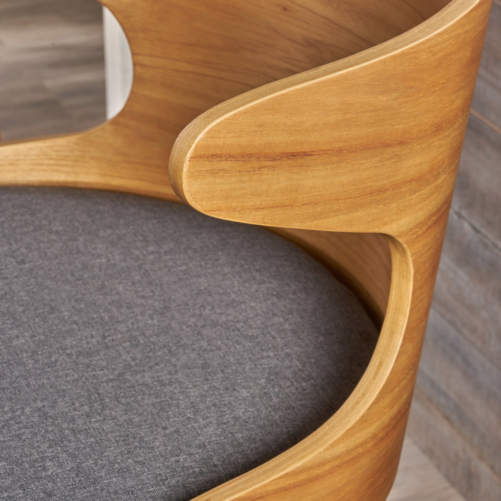 Modern curved wooden chair with dark gray fabric seat