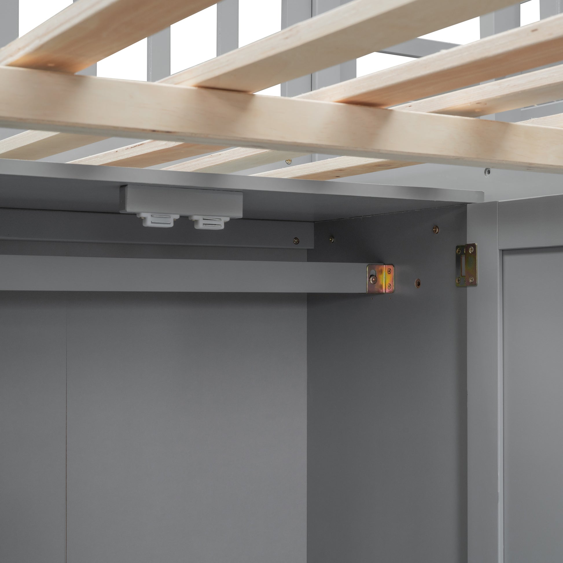 Closeup of wooden slats on a gray bed frame with metal brackets