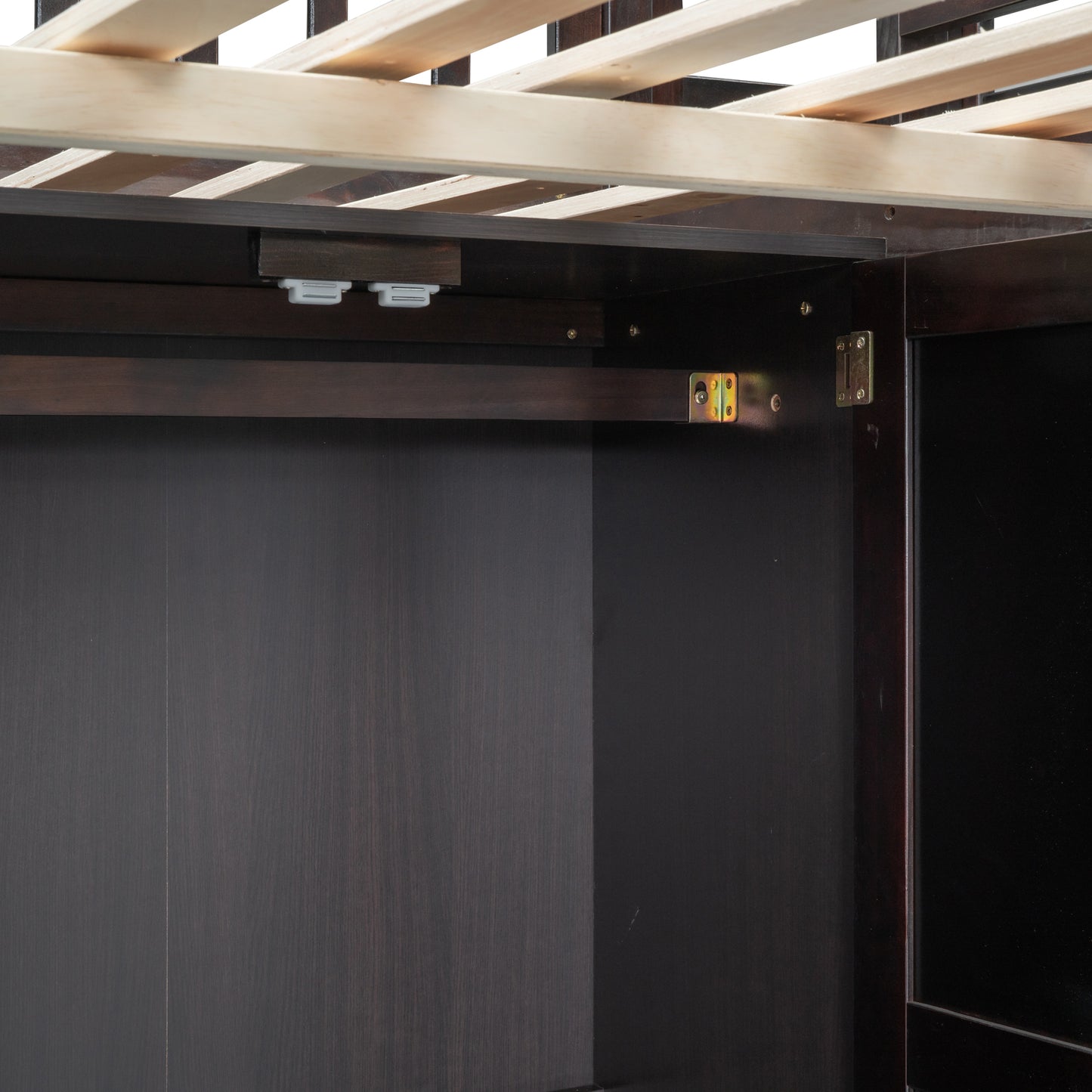 Dark wood bed frame interior with wooden slats and metal bracket