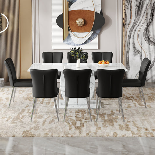 Black leather dining chairs with chrome legs around a white marbletop table