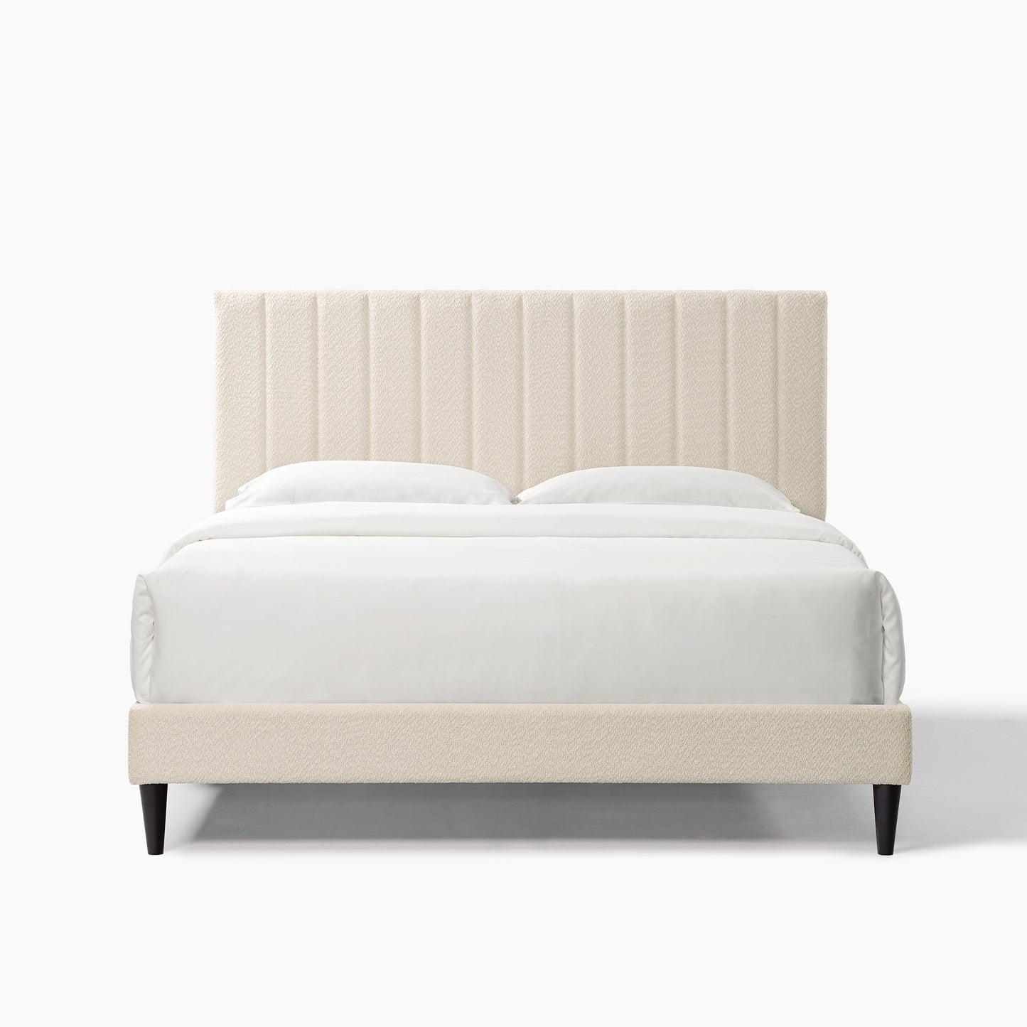 Cream boucle upholstered bed frame with vertical channel tufting on headboard