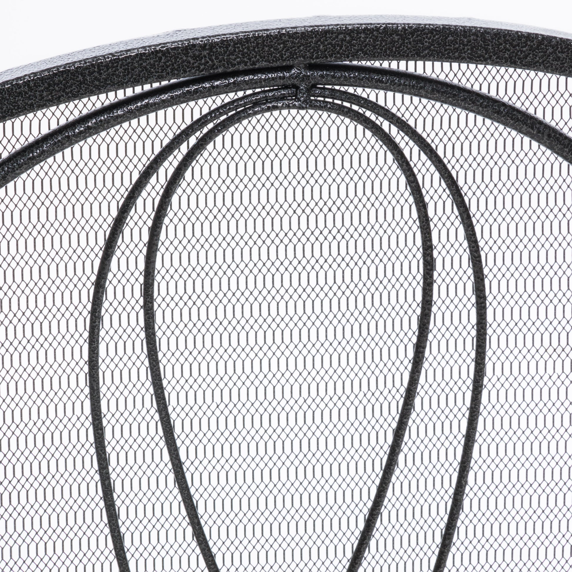 Closeup of intricate dark gray metal mesh with curved decorative bars Decorative fireplace screen detail