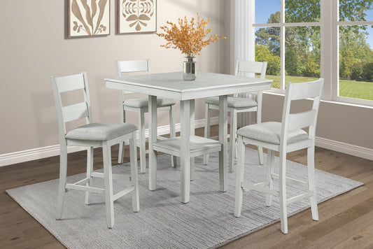 White distressed wood counter height table set with four upholstered stools