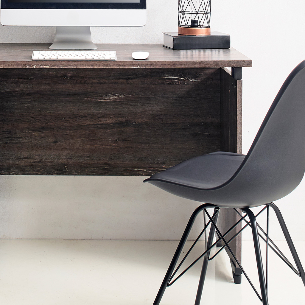 Dark wood desk with modern monitor and black ergonomic chair