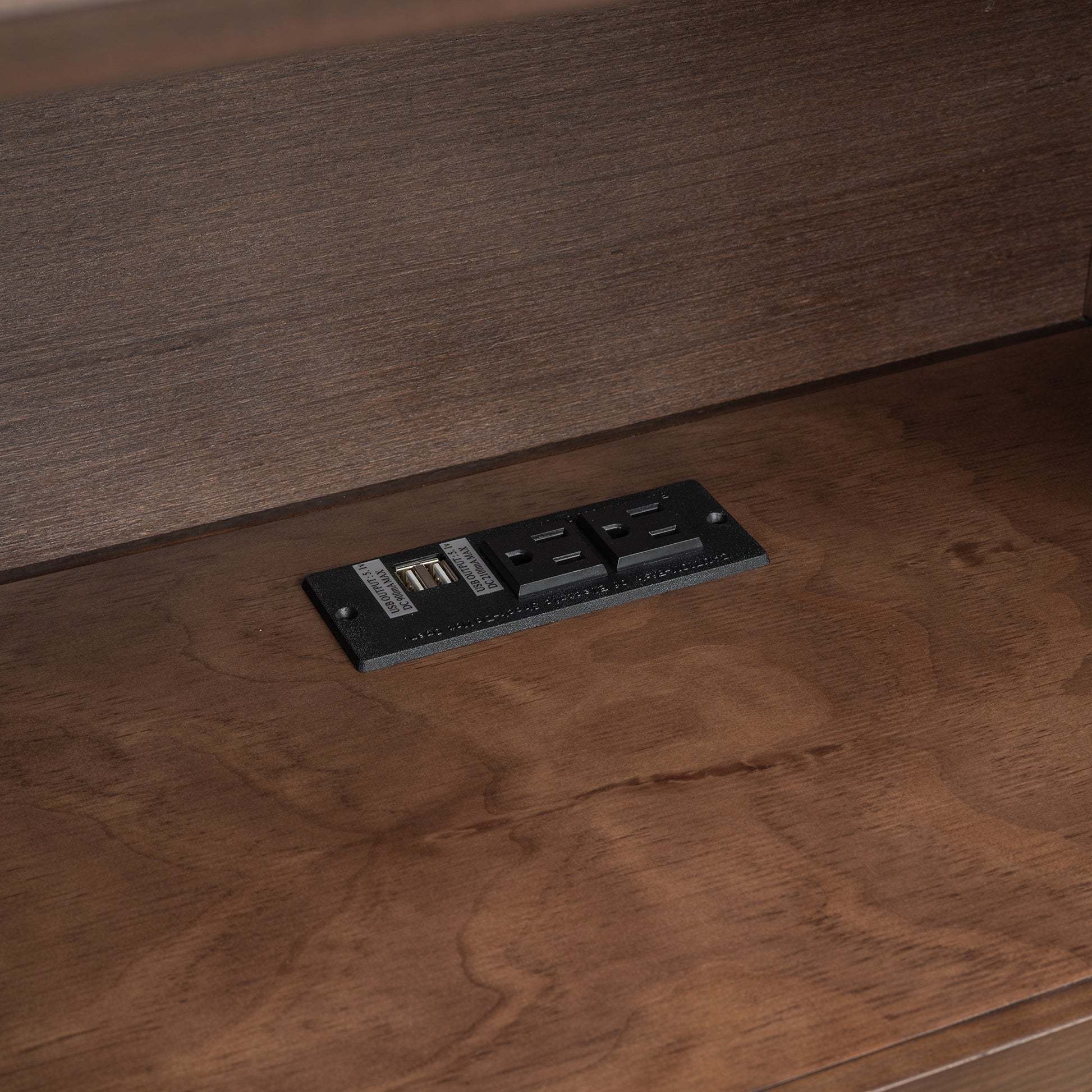 Black flush mount power outlet with two USB ports and two AC outlets
