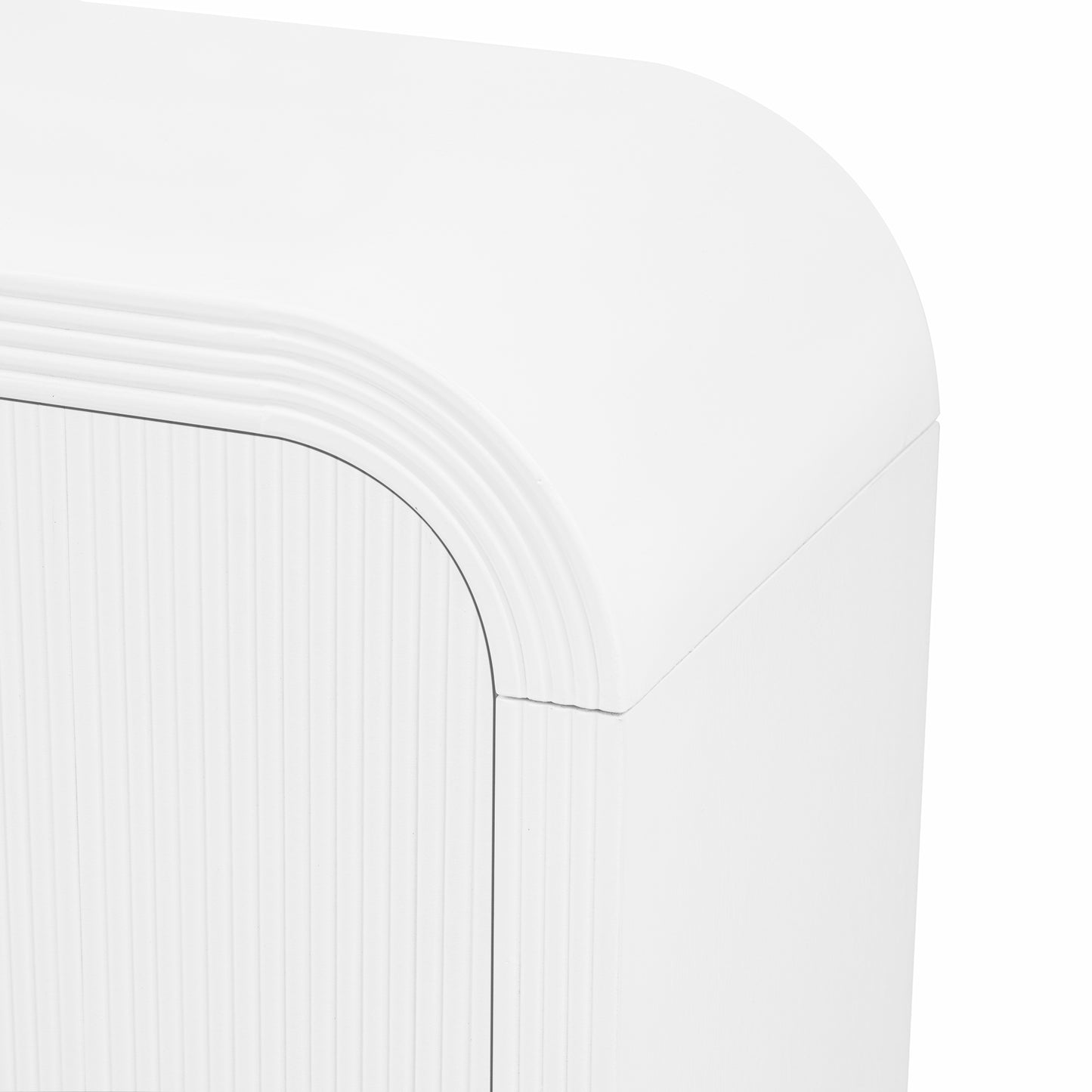 Closeup of a white curved cabinet with fluted detailing on the door