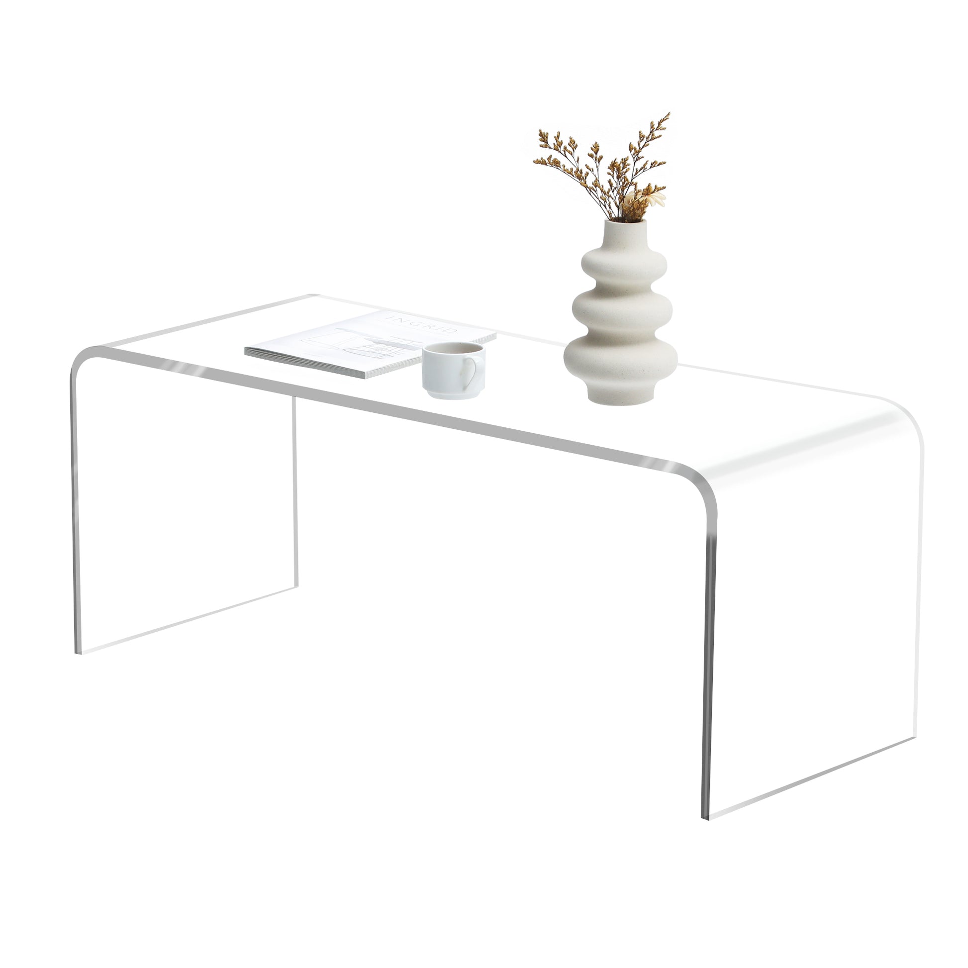 Curved clear acrylic coffee table with stacked wavy vase and white mug