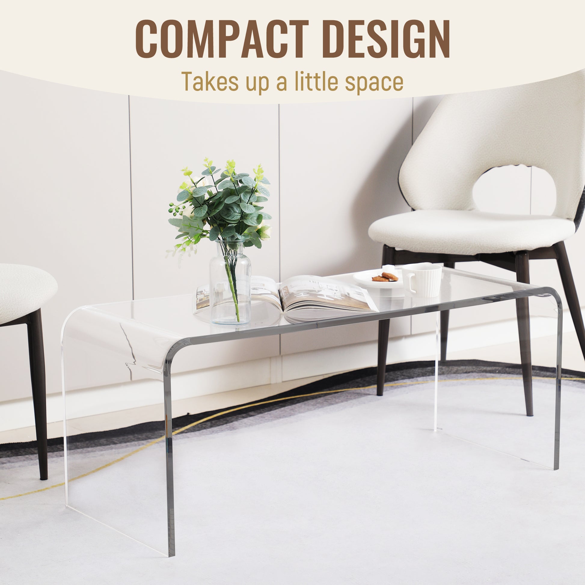 Transparent acrylic coffee table with curved edges featuring a book and flowers