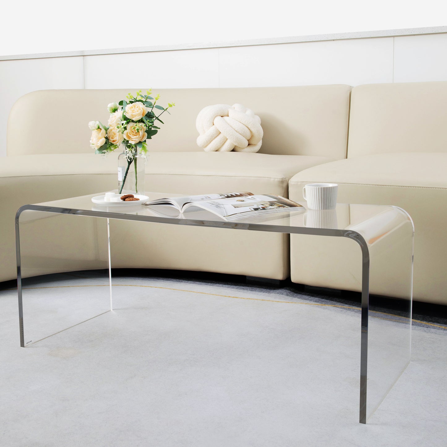 Clear acrylic coffee table with modern curved design